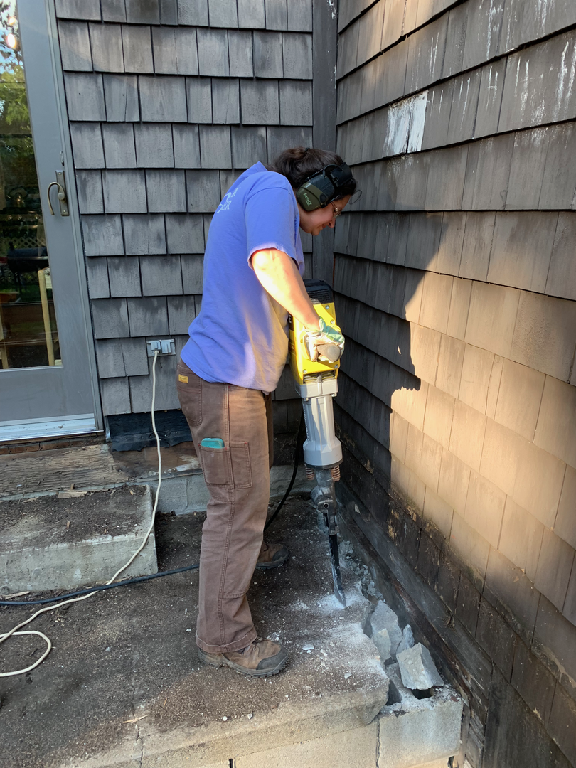 We found a broken concrete patio under it (that should have been removed!) and broke off the edges so we could see what we'd won!